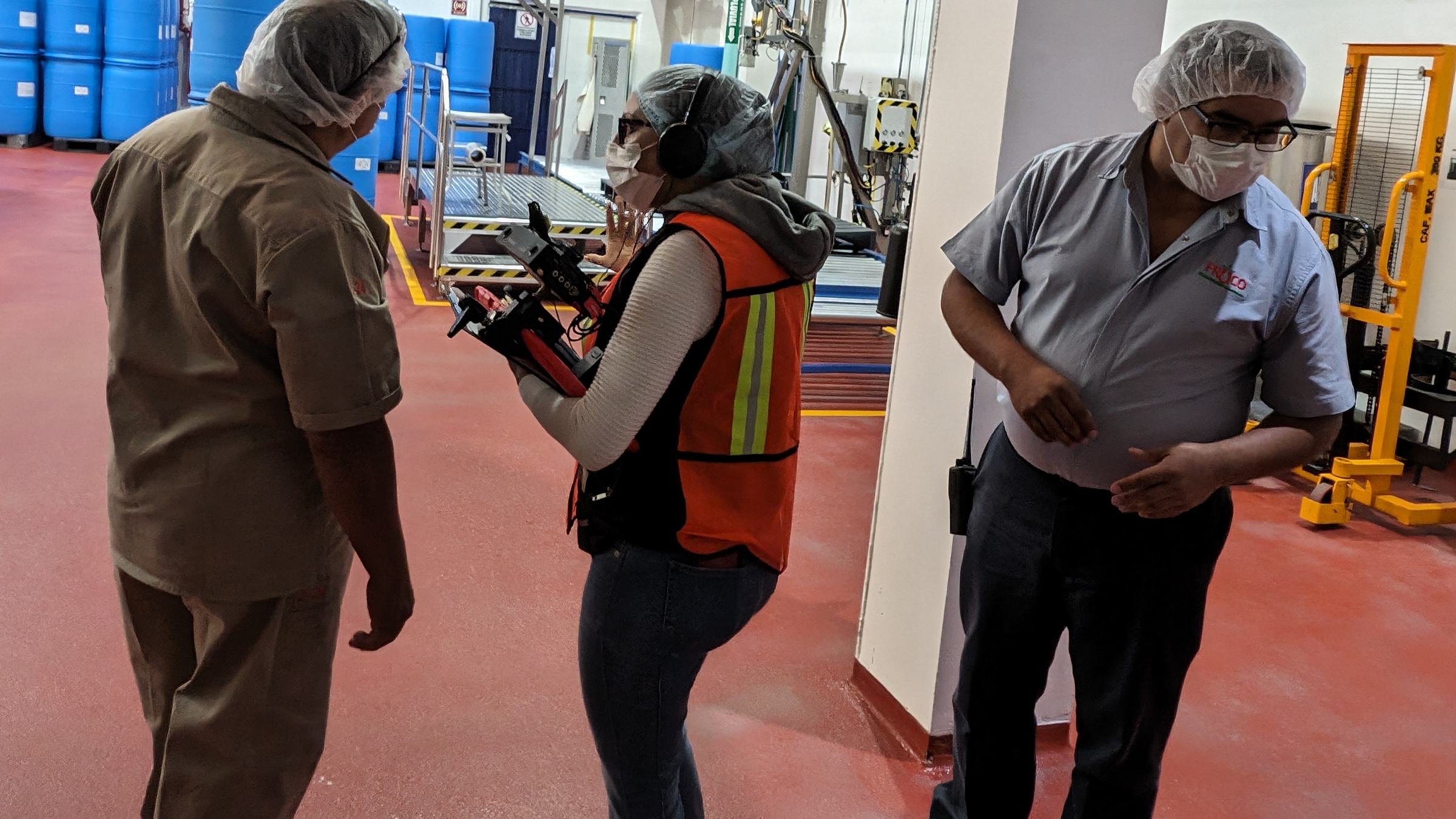 NDA crew directing and filming with plant staff during the Jarritos documentary