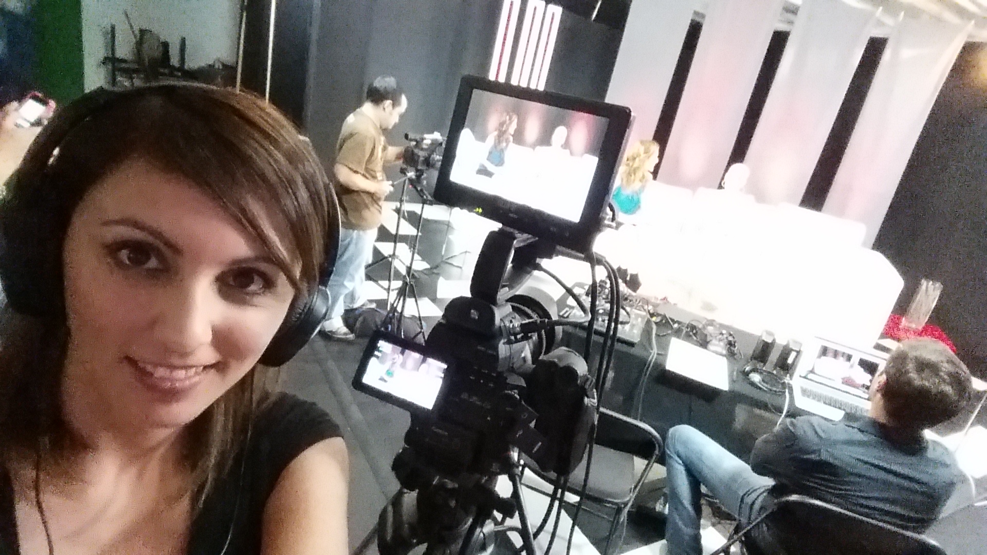 Crew-side BTS selfie with the Ivy Queen interview set in the background